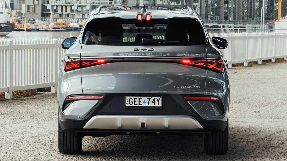 A Harbour Grey BYD Atto 3 Evo, with its taillights and brake lights illuminated