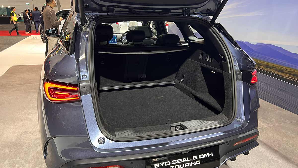 Tailgate open to provide look into cargo area of BYD Seal 6 Touring wagon at Melbourne motor show.