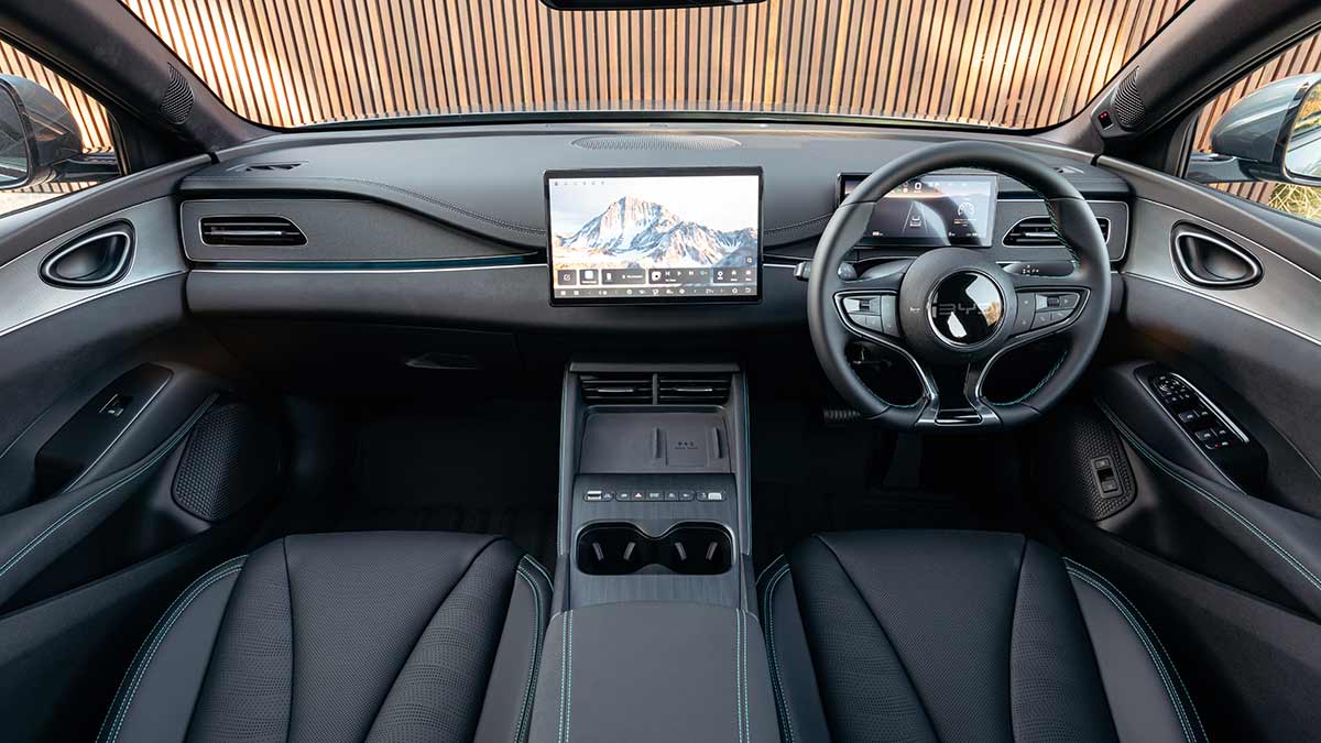 Front cockpit of BYD Seal 6 Touring wagon with dark trim, dual digital screens and wave design across dash.