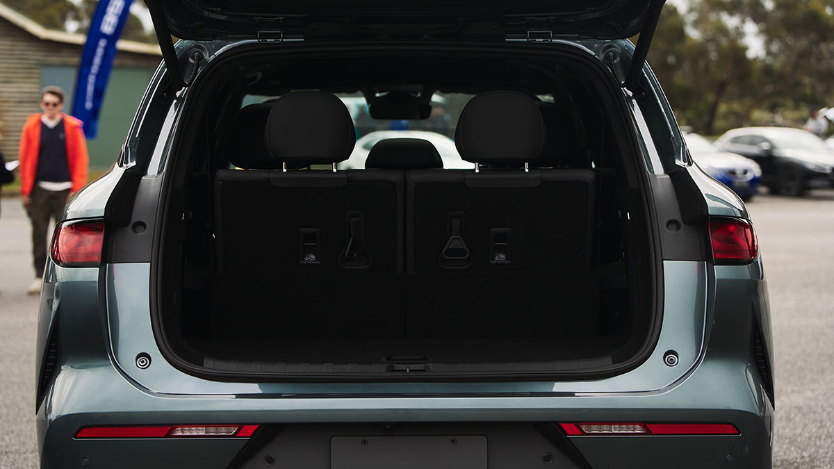 BYD Sealion 8 large SUV in dark aquamarine metallic colour with tailgate open showing view into cargo area.