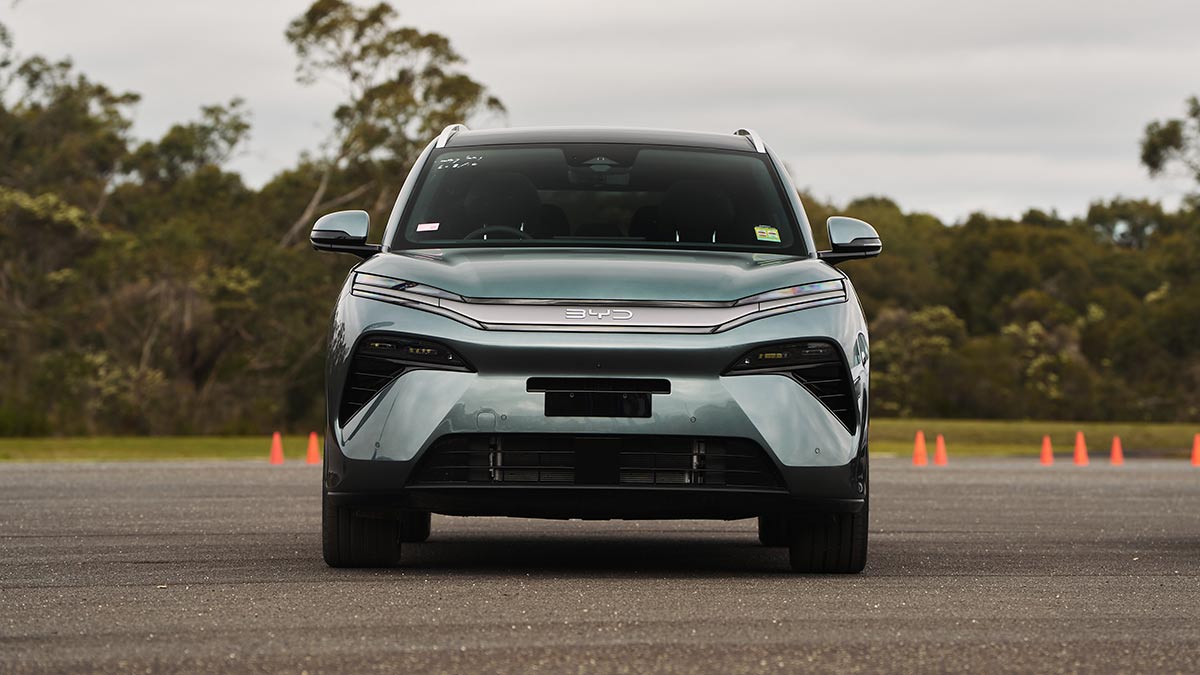 Front-on view of BYD Sealion 8 large SUV in dark aquamarine metallic colour parked on forecourt at bushy Lang Lang proving ground in regional Victoria.