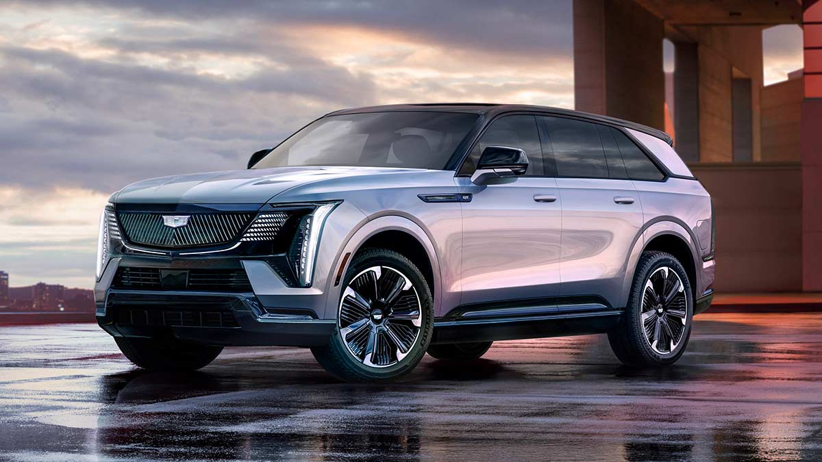 Silver Cadillac Escalade IQ full-size luxury SUV on wet rooftop carpark