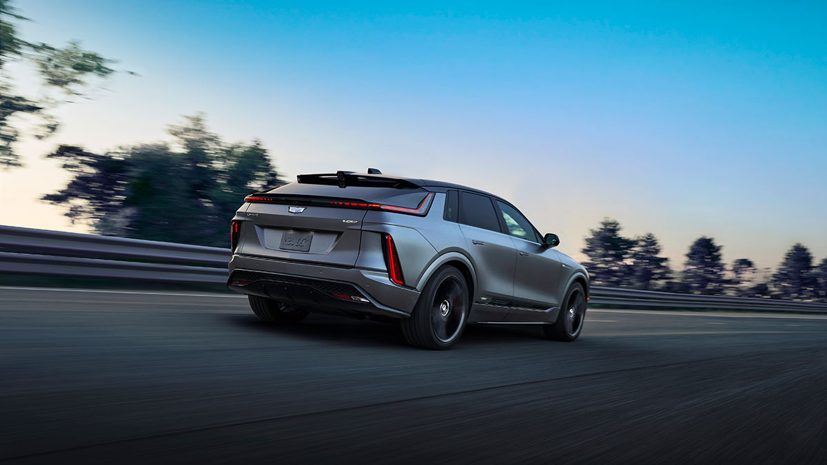 Rear view of Silver Cadillac Lyriq-V performance SUV on high-speed bowl at a General Motors proving ground