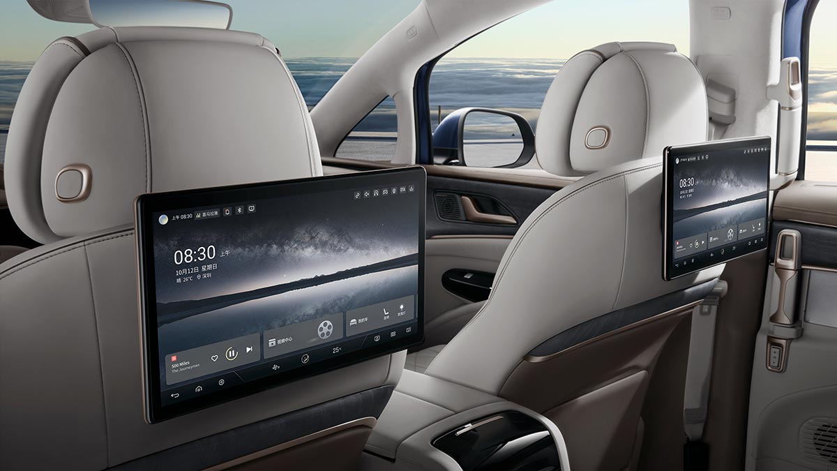 Large infotainment screens in Denza D9 MPV behind front seats for second row passengers.