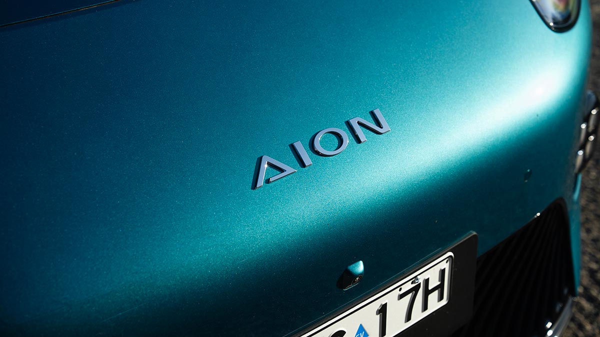 Close-up of green GAC Aion UT EV bonnet showing front camera and Aion badge.