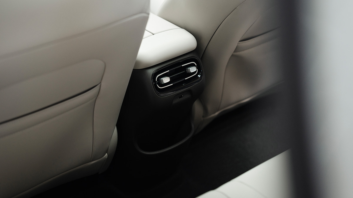 Rear seat area of GAC Aion UT showing air vents, USB port, seatback pockets and flat floor with lots of legroom.