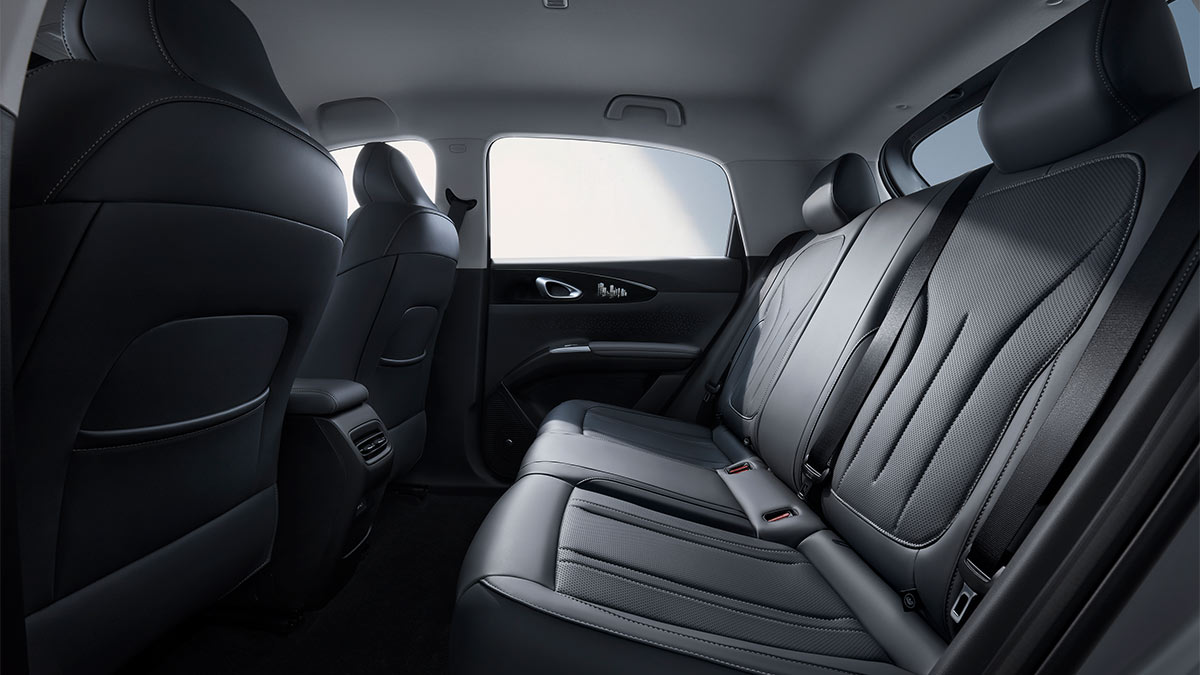 Rear seat area of Geely EX2 small hatch with dark grey trim and light grey headlining.