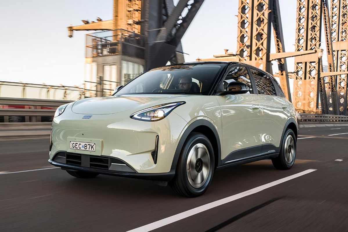 Light green Geely EX2 electric hatch driving across the Sydney Harbour Bridge.