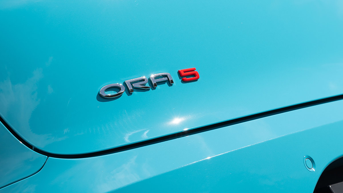 GWM Ora 5 badge with red 5 on duck-egg blue small SUV’s tailgate.