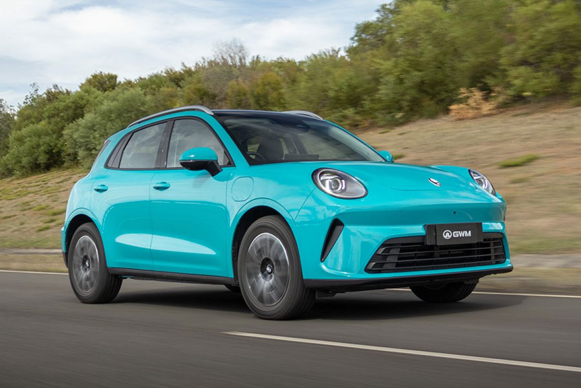Duck-egg blue GWM Ora 5 electric small SUV driving on ride and handling circuit at Lang Lang proving ground in Victoria.
