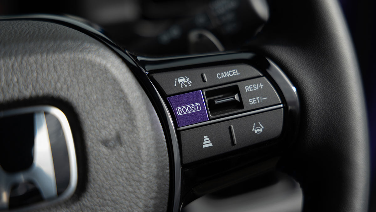 Detail of Honda Super-One EV steering wheel with purple Boost mode switch.