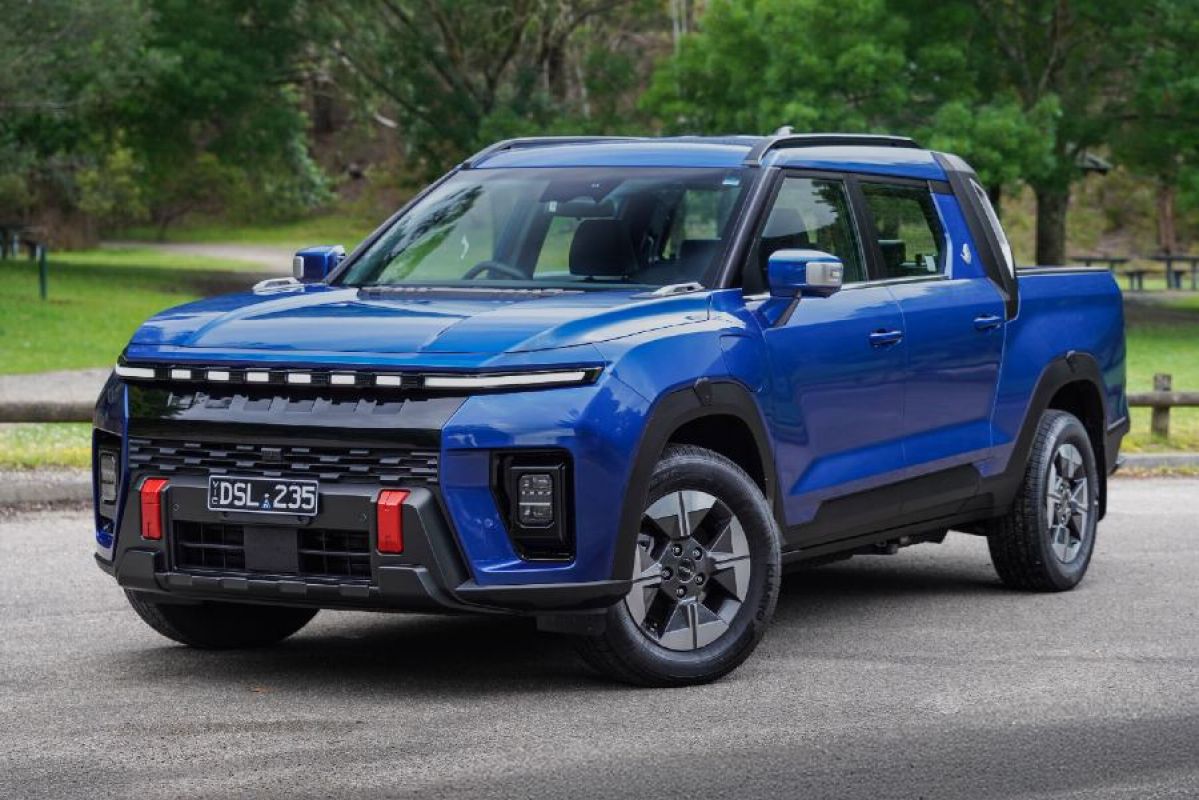 dark blue 2026 KGM Musso EV parked on road