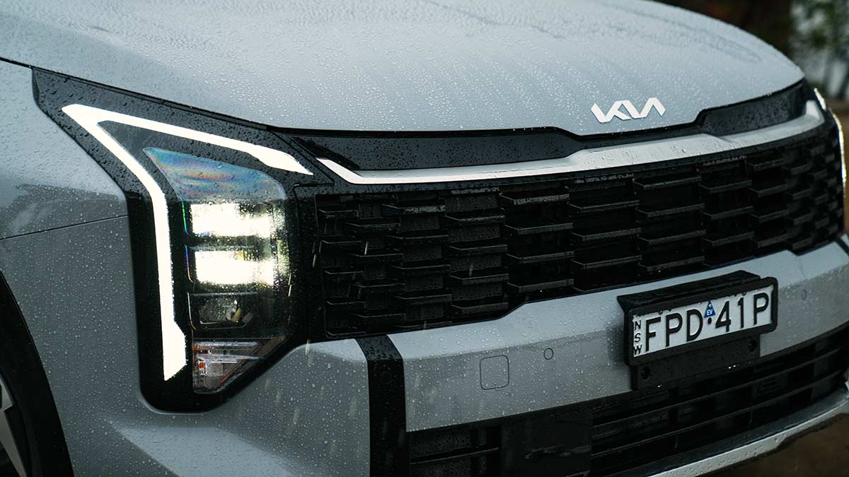 Front-end close-up of Kia Sportage SX Hybrid showing new squared-off grille and vertical headlight cluster
