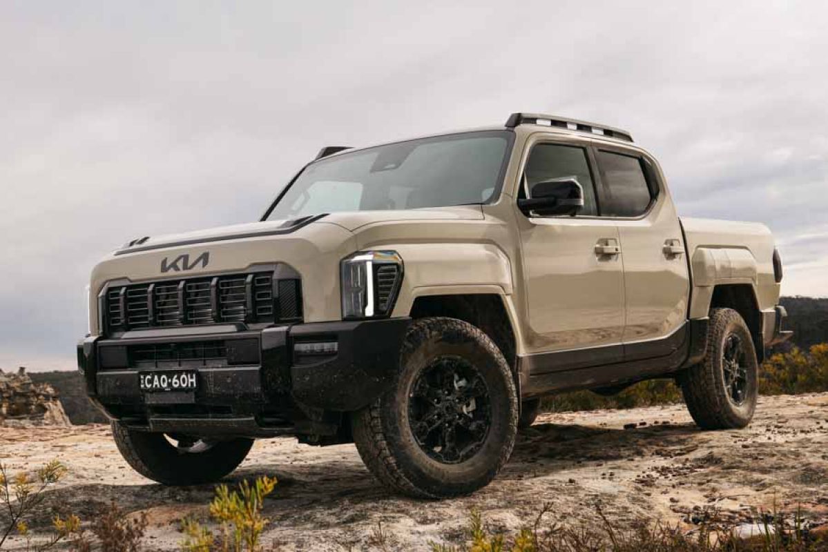 Kia Tasman X-Pro in Tan parked offroad