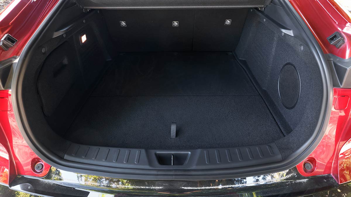 Tailgate open for Mazda 6e liftback sedan, showing cargo area with rear seats upright.