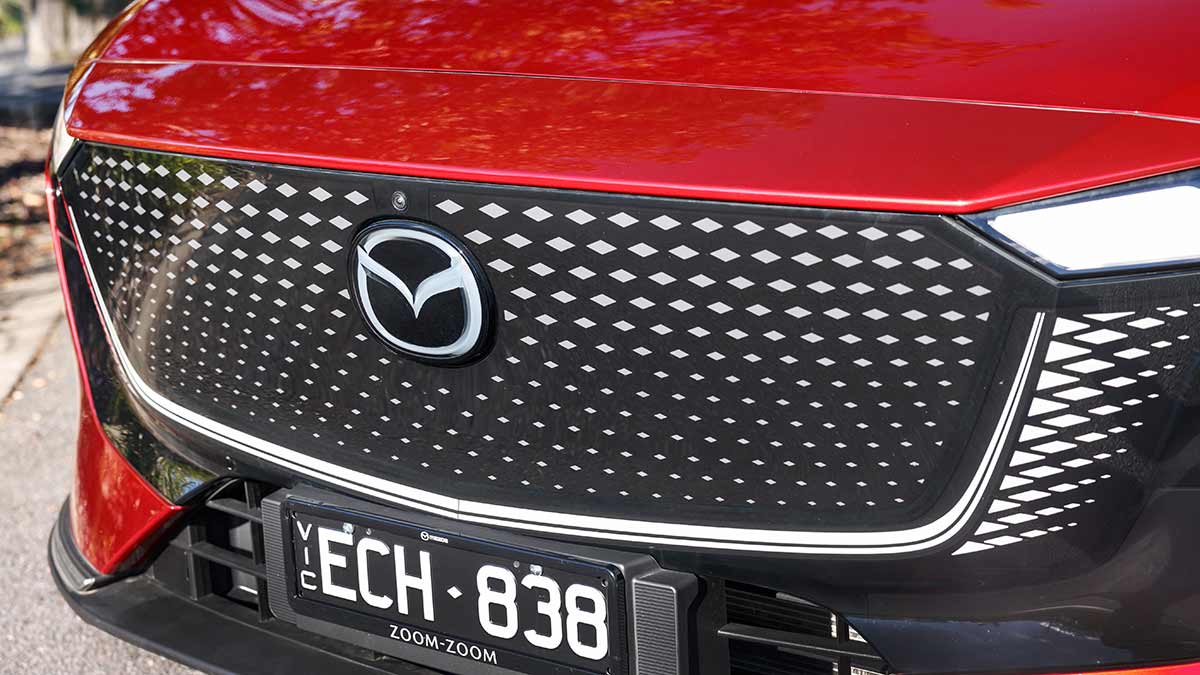 Mazda 6e electric sedan's fully enclosed front grille area with diamond pattern and large brand logo.