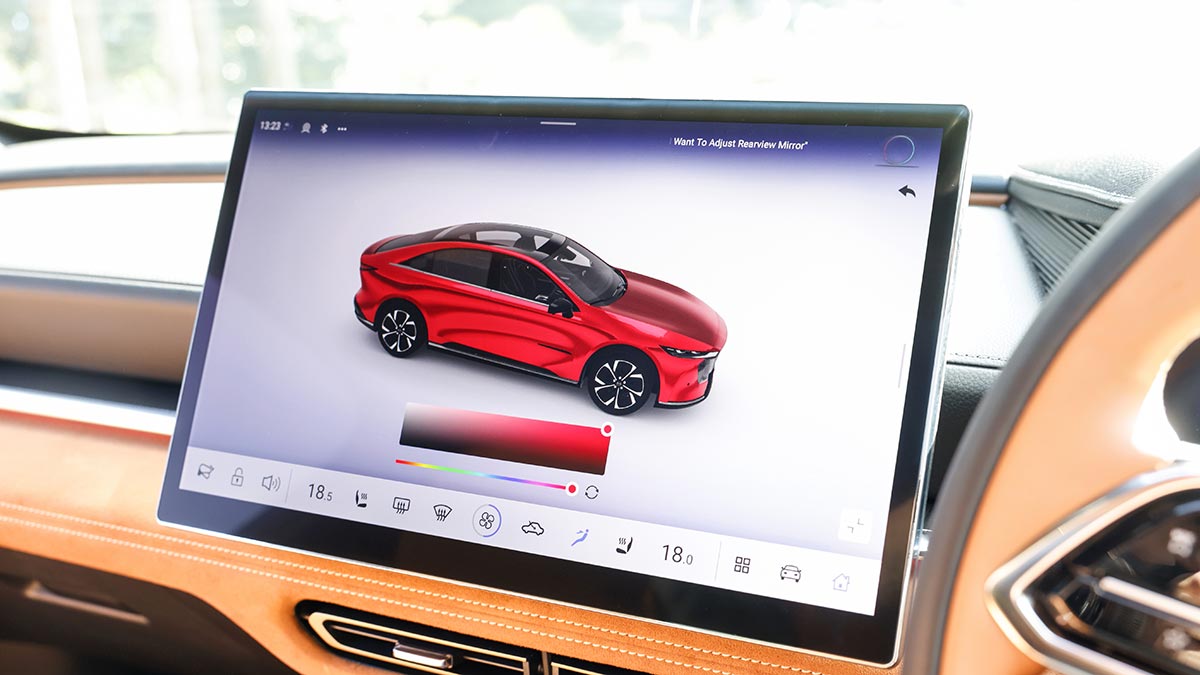 Large central touchscreen on Mazda 6e electric sedan with image of red car on display.