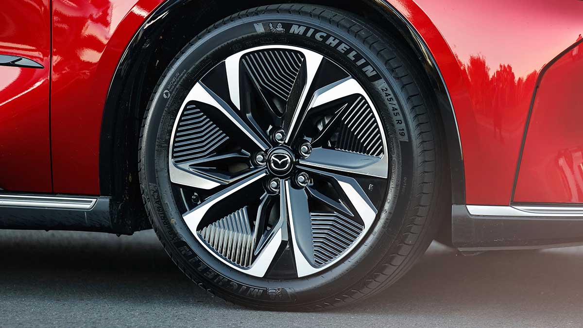Red Mazda 6e EV's front left 19-inch black and silver alloy wheel with Michelin tyre.