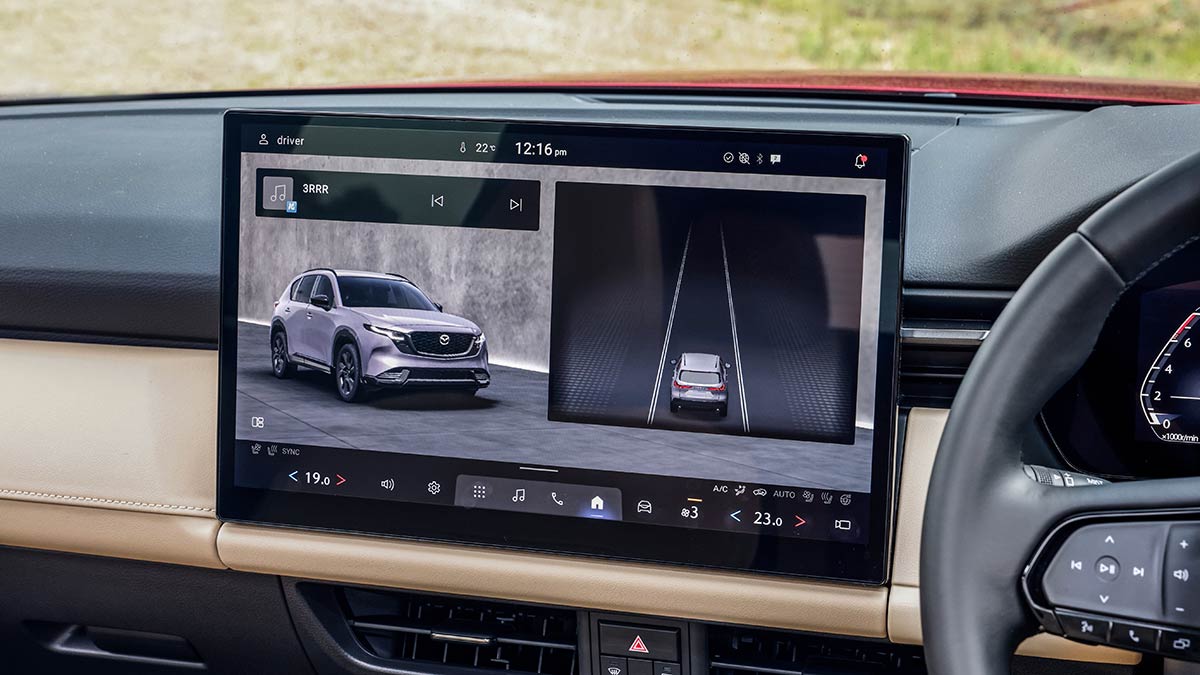 Mazda CX-5 Akera SUV’s large 15.6-inch central infotainment touchscreen with image of car on screen and graphic showing position in lane.