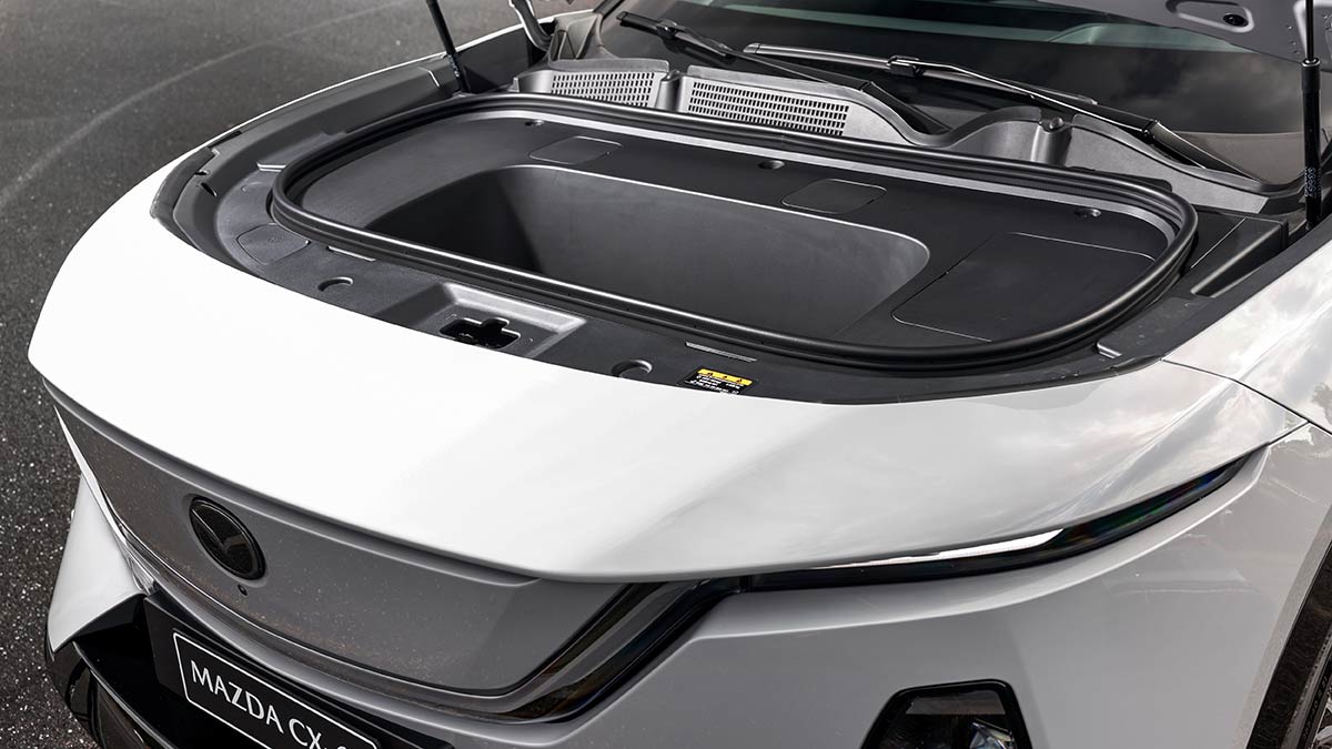 White Mazda CX-6e SUV with bonnet open, showing 80-litre storage container underneath.