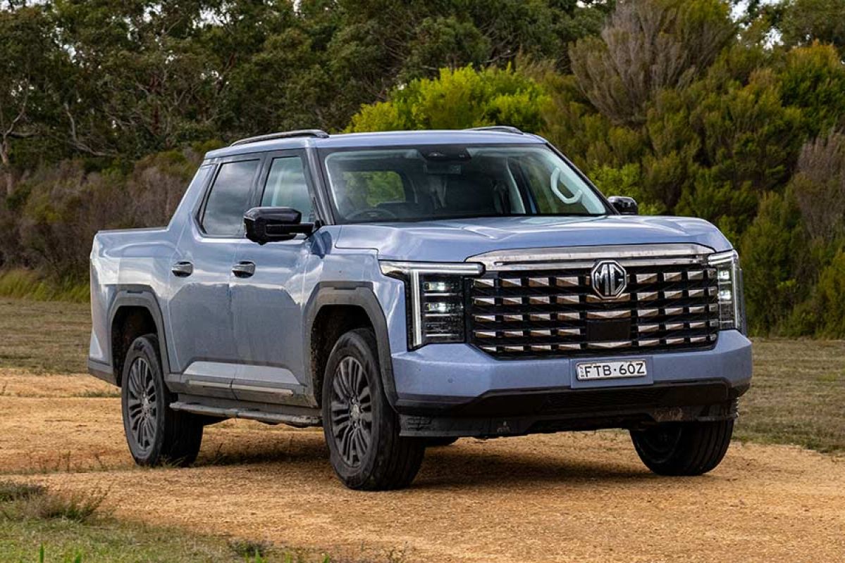 Blue MG U9 dual-cab ute on rutted track surrounded by bush.