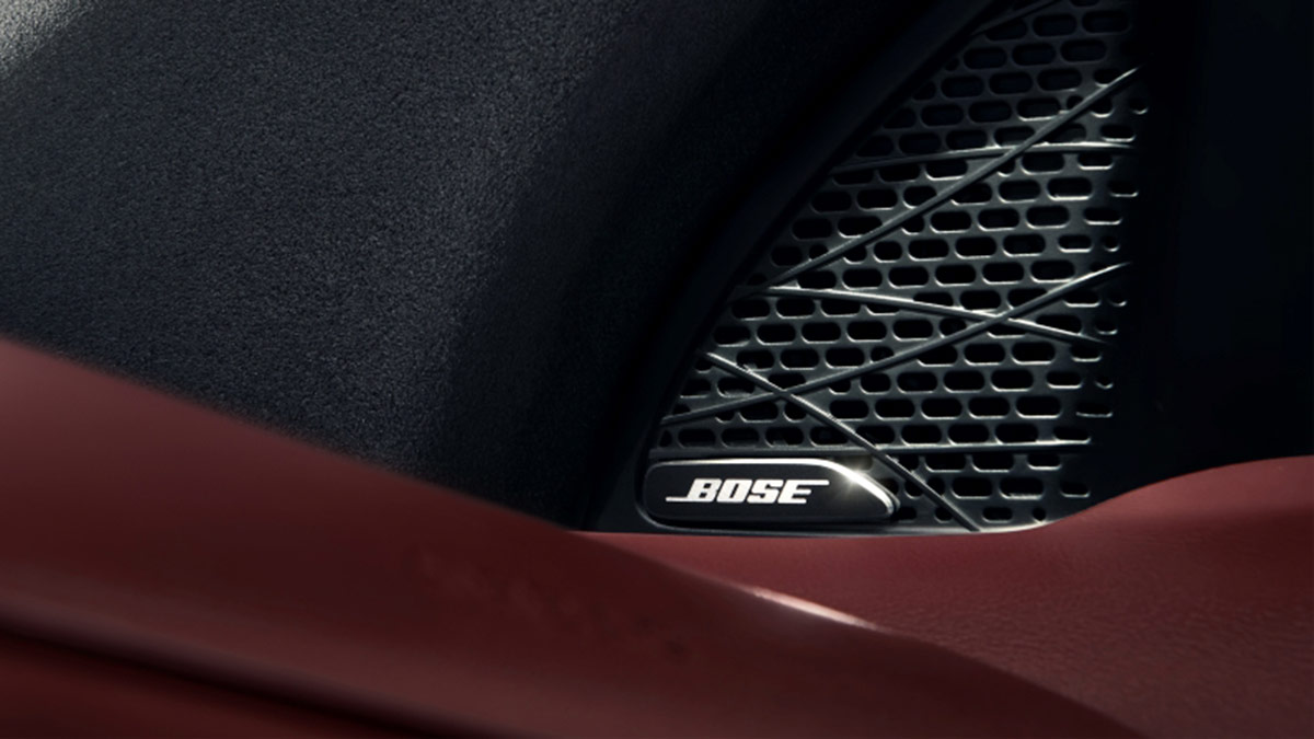Black Bose speaker in red door trim of MG7 sports sedan.