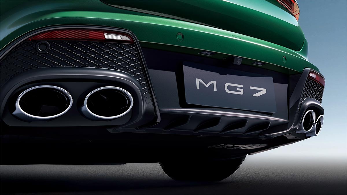 Quad tailpipes in lower black bumper of green MG7 sports sedan.