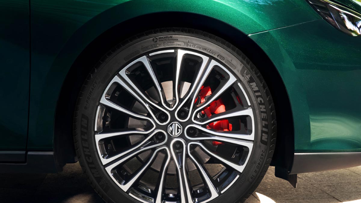 Green MG7 sedan's front-right 19-inch multi-spoke alloy wheel, low-profile Michelin tyre and red brake calliper.