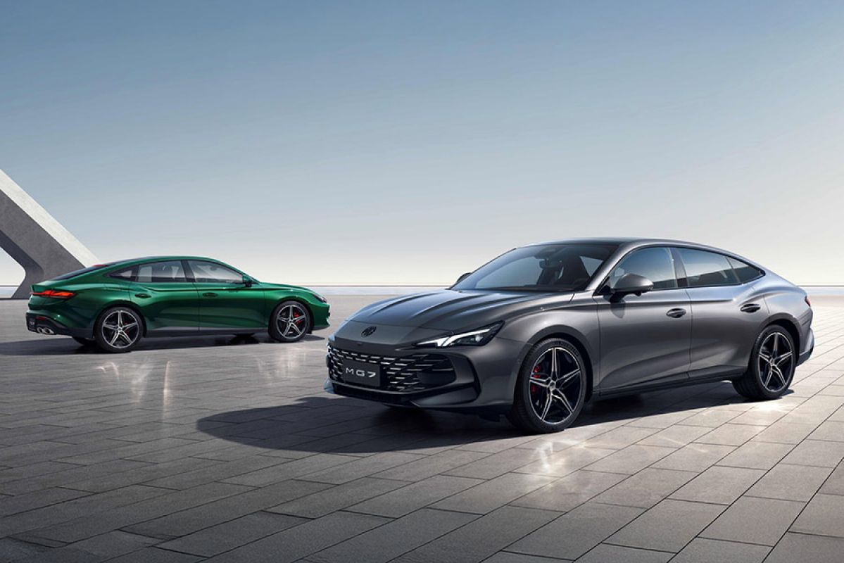 Grey metallic MG7 sports sedan in foreground and rear quarter view of green MG7 behind in open landscape.