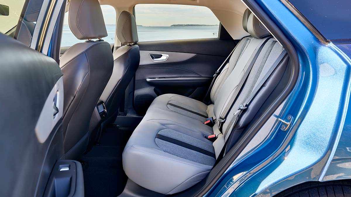 Rear seats with light grey trim in MG4 electric hatchback as seen through left rear door.