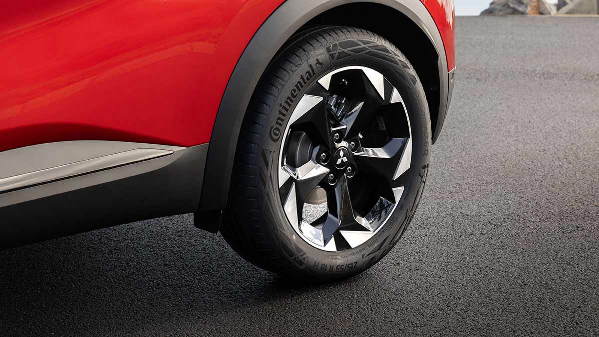 Close-up of red Mitsubishi ASX with 18-inch black and silver alloy wheel and Continental tyre. 