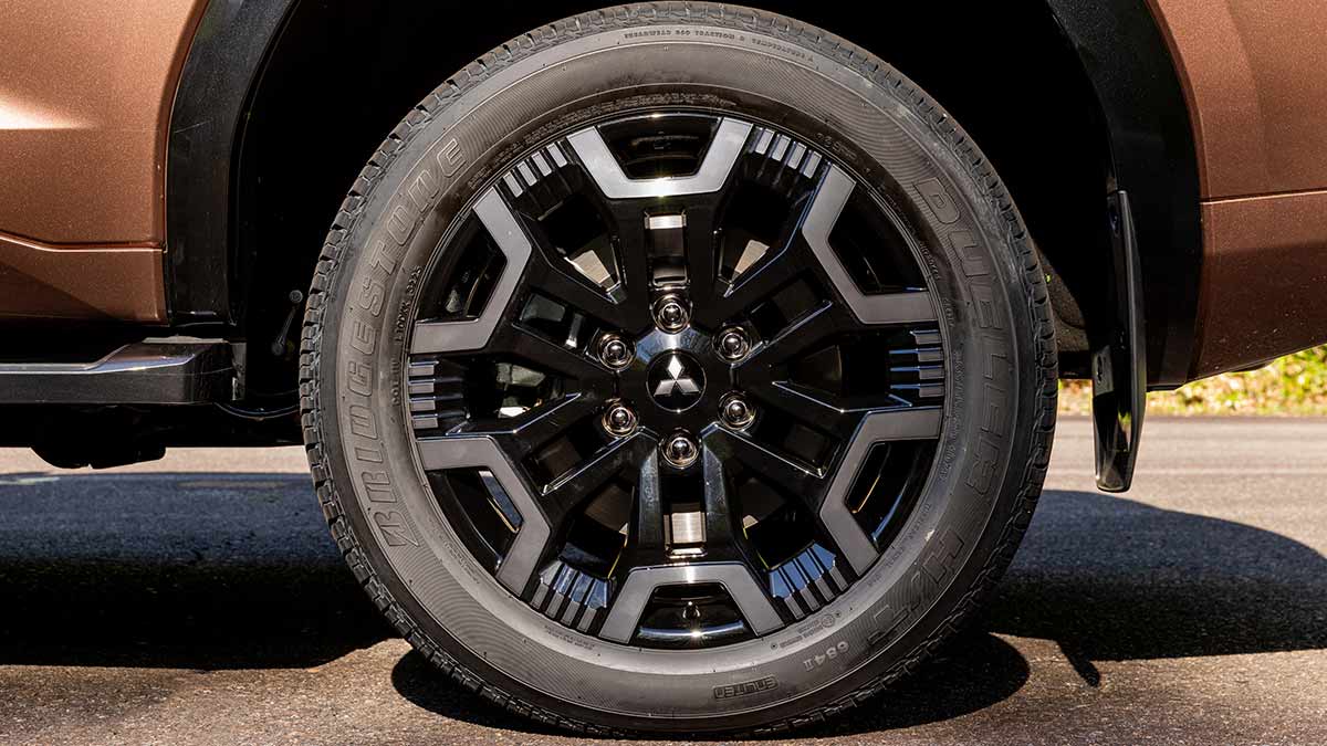 Black and silver 20-inch alloy wheel design on new Mitsubishi Pajero SUV.