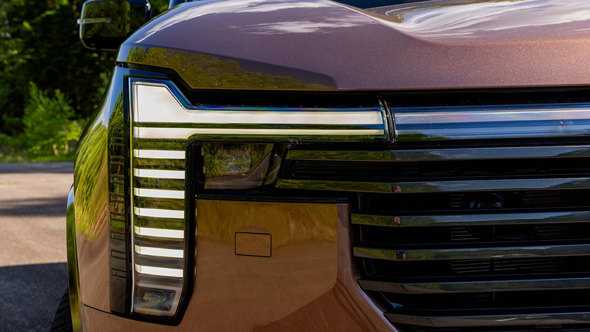 T-shaped LED headlights on Mitsubishi Pajero SUV with ladder-style horizontal elements.