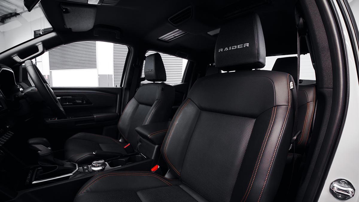 Dark leather trim in Mitsubishi Triton Raider ute cabin with Raider logo on front headrests.