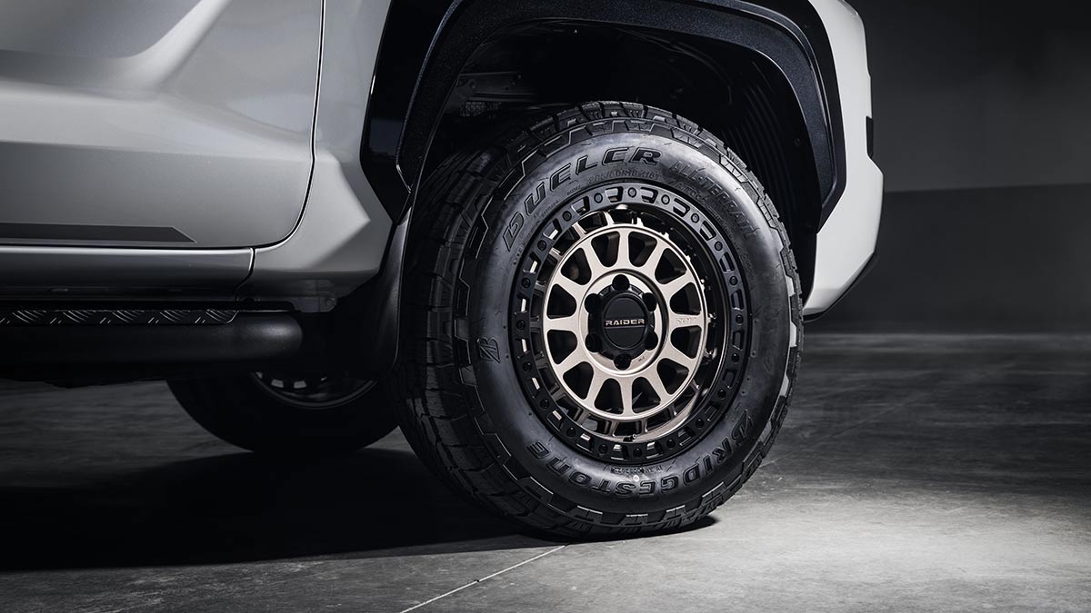 New 18-inch ROH bronze-coloured alloy wheel and Bridgestone all-terrain tyre on white Mitsubishi Triton Raider ute.