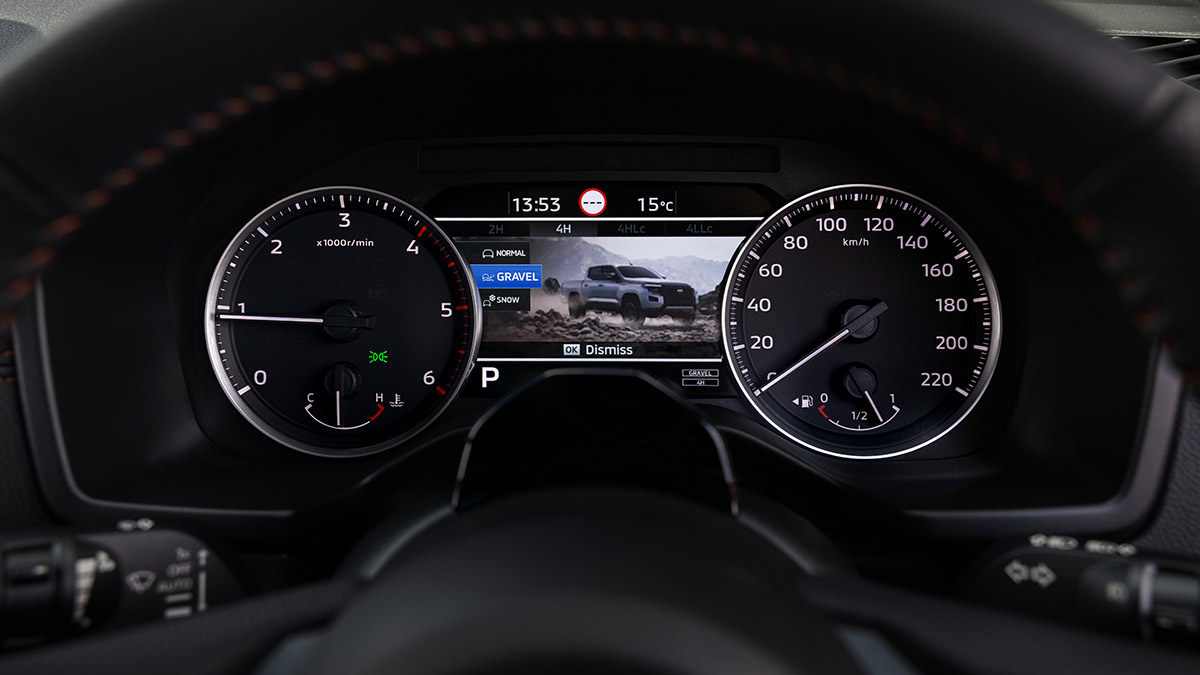 Instrument panel in Nissan Navara Pro-4X with two analogue dials and central digital screen showing off-road modes.