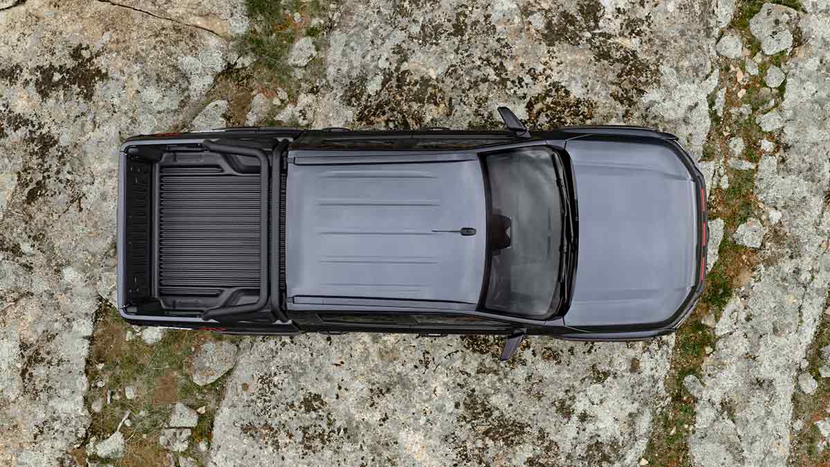 Overhead view of dark grey Nissan Navara Pro-4X on rocky granite hilltop.