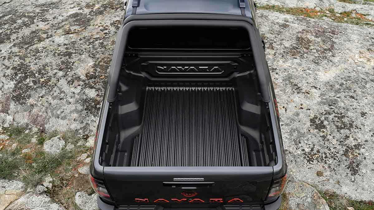 Overhead view showing open tub area of dark grey Nissan Navara Pro-4X on rocky granite hilltop.