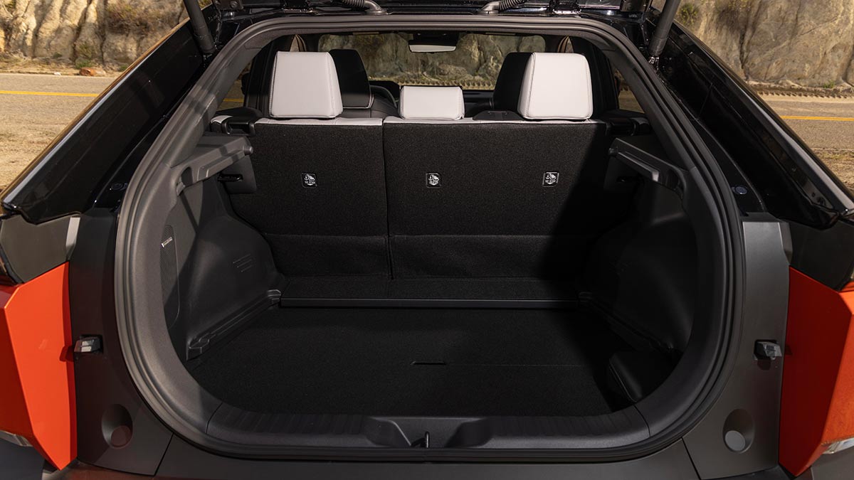 Tailgate open of Subaru Uncharted small SUV showing cargo area with dark trim and split-fold rear seats.