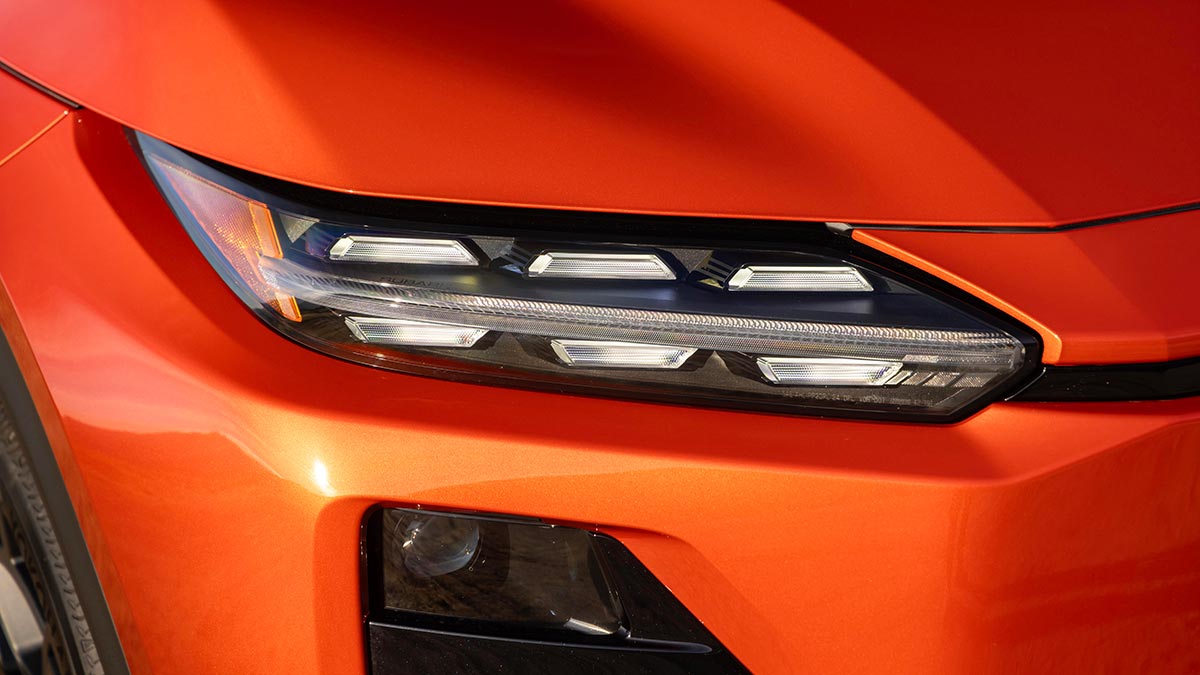 Narrow LED headlight design on orange metallic Subaru Uncharted small SUV.
