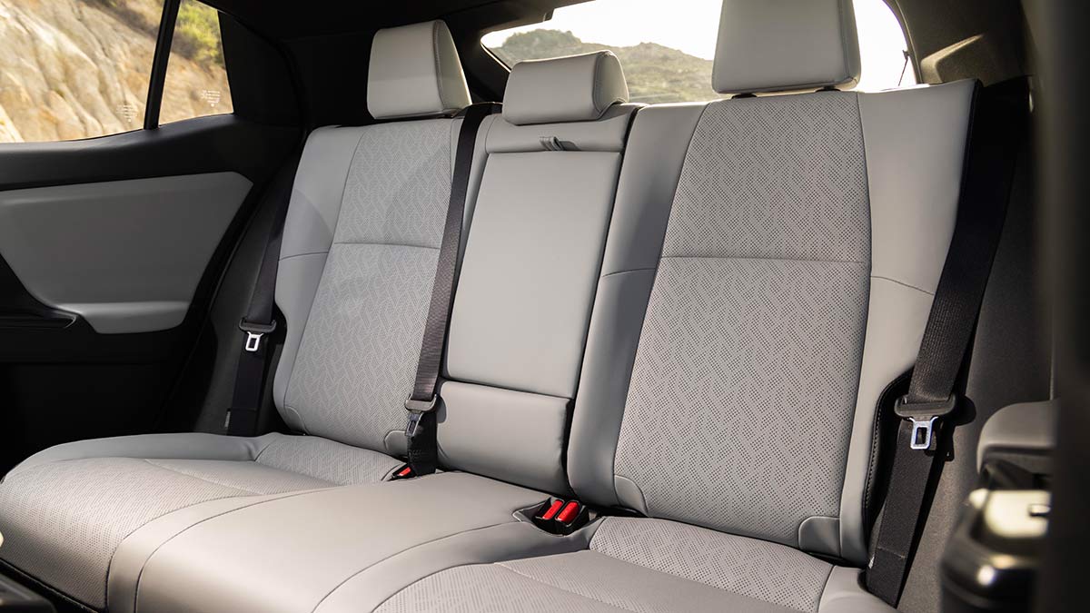 Back seat of Subaru Uncharted small SUV with light grey upholstery and darker grey trim on doors and roof.