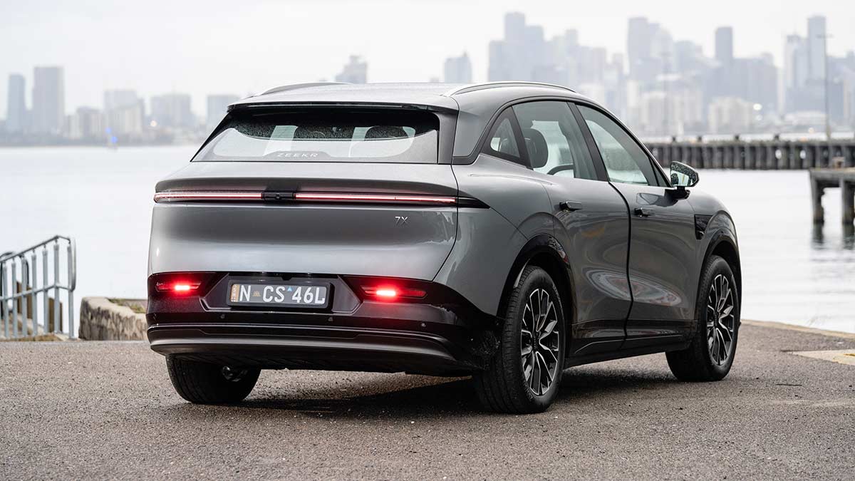 Rear view of metallic grey Zeekr 7X medium electric SUV parked at waterfront at Williamstown with Melbourne CBD behind.