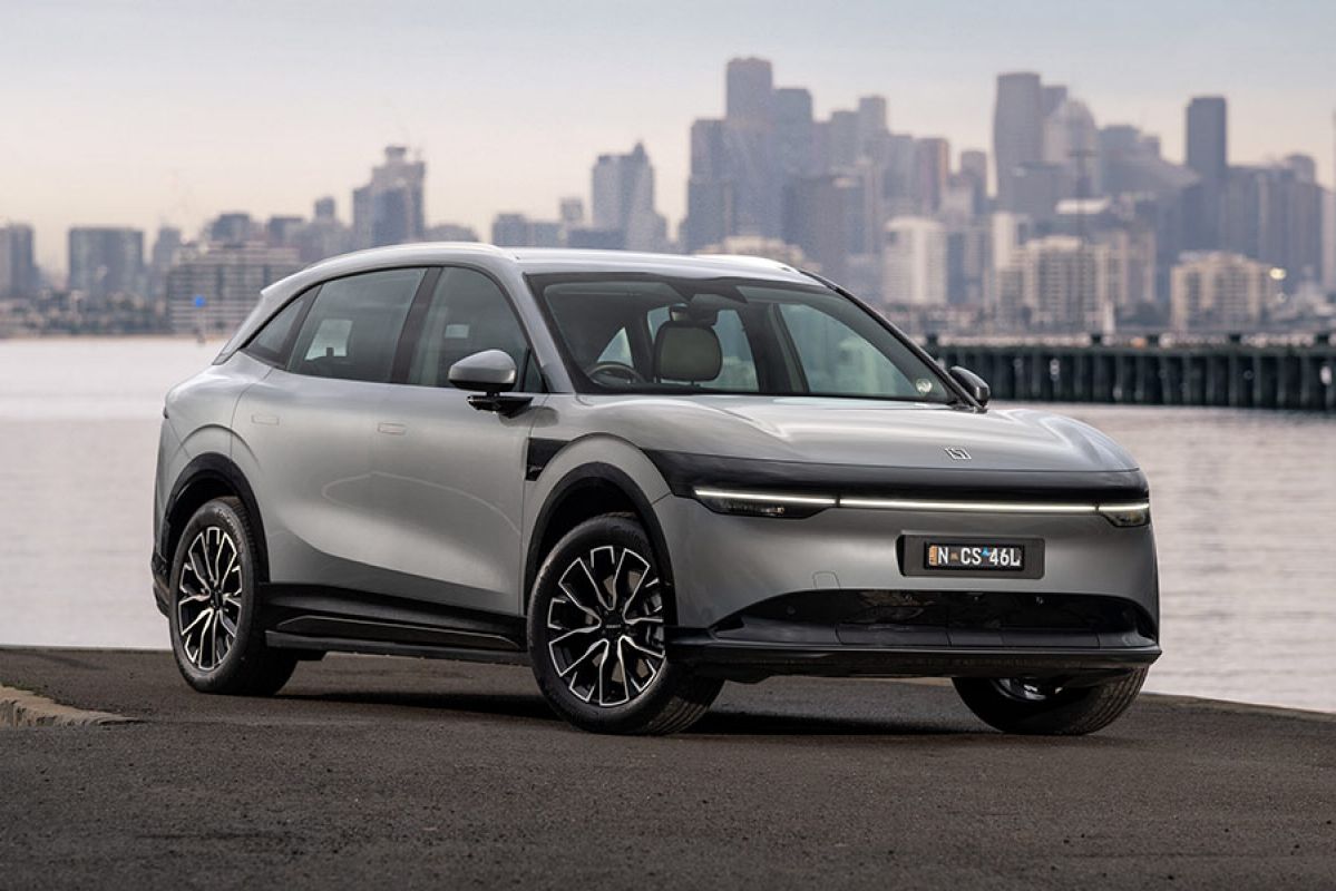 Metallic grey Zeekr 7X medium electric SUV parked at waterfront at Williamstown with Melbourne CBD behind.