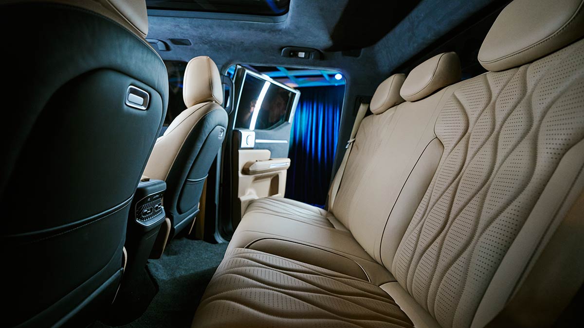 Roomy rear seat area of Chery KP31 ute with air vents, charge points and ventilated seats with tan trim.