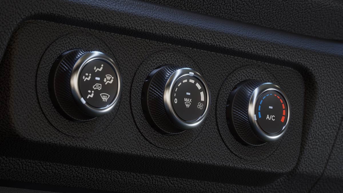 Manual air-conditioning controls with three rotary dials on dash of Ford Transit City electric van.