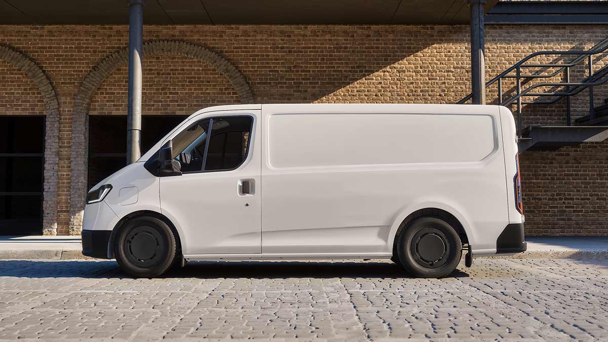 Side-on view of white European-spec Ford Transit City van parked on brick-paved forecourt of double-storey heritage industrial building.