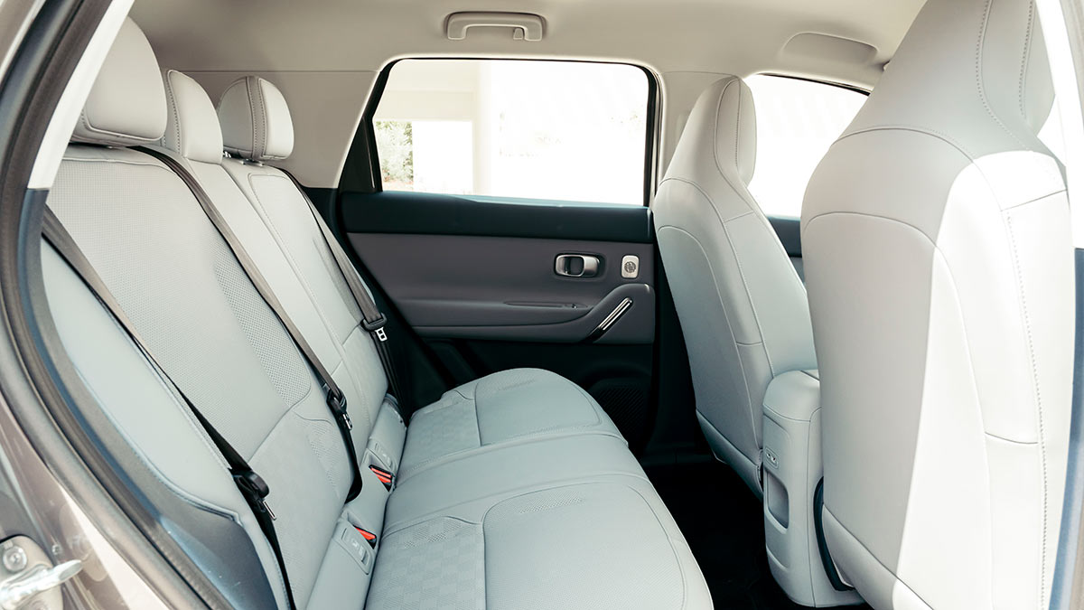 Rear seat of Leapmotor B03X small electric SUV with light grey seat upholstery and contrasting dark door trim.
