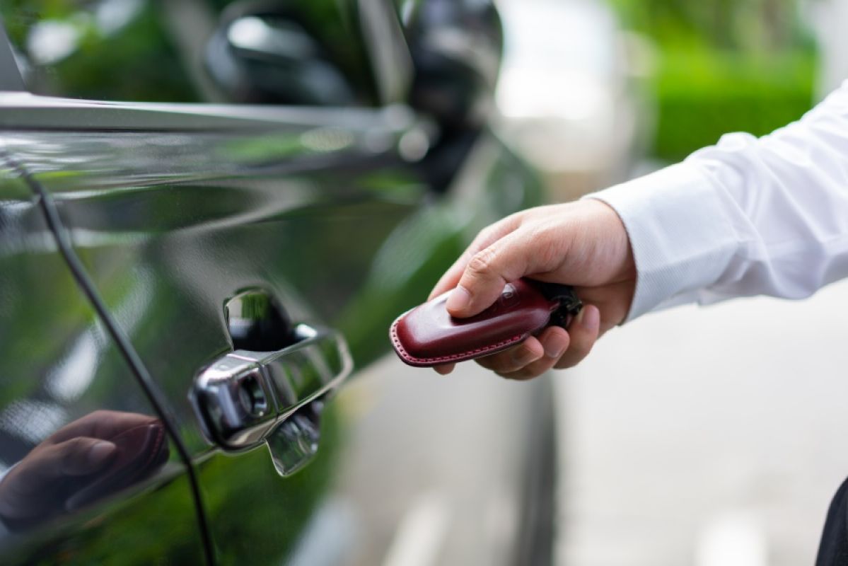 person locking car with remote fob