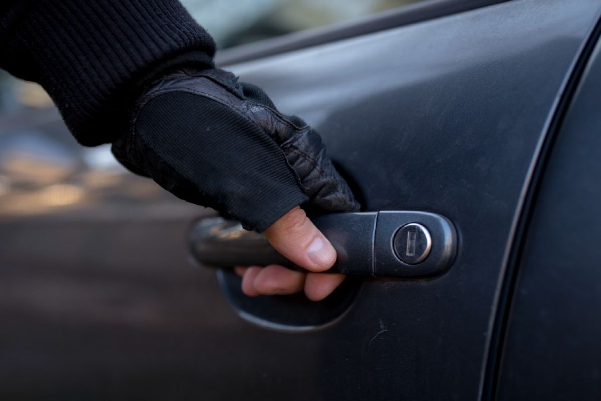 car thief opening car door
