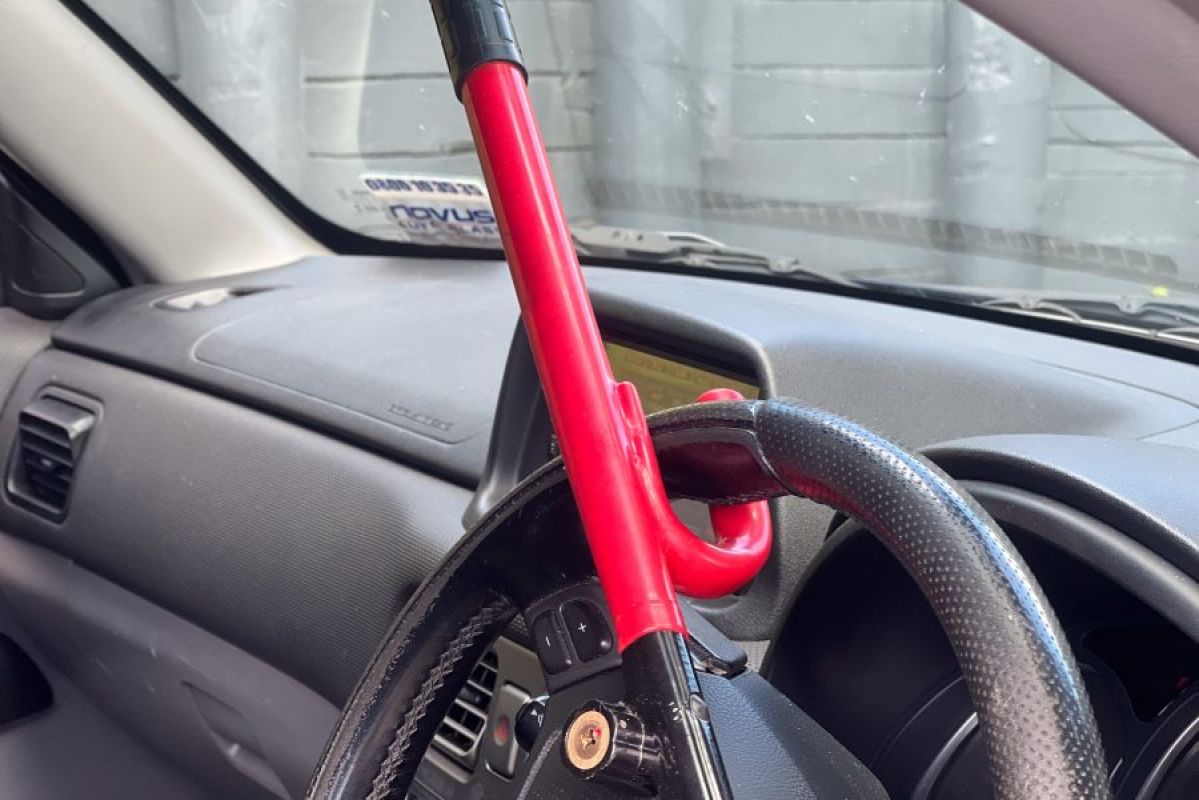 A red bar car steering wheel lock on a steering wheel